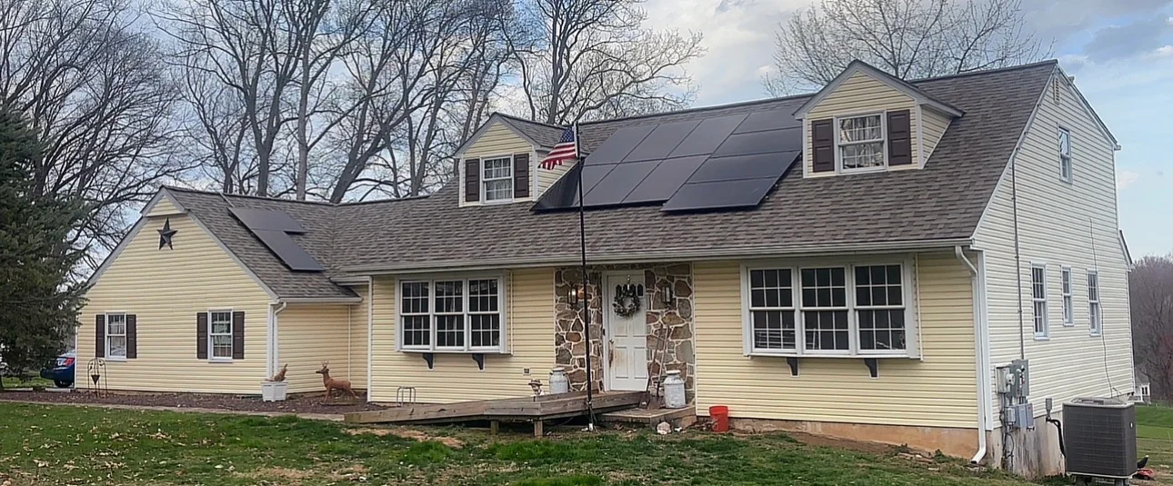 Solar panels installed on cream-colored two-story home with dormers in Mohnton, PA